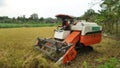 Rice harvesting machines on agricultural land Royalty Free Stock Photo