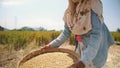 Rice Harvesting Process. Asian Farm Worker Women Sifts and Throws Rice at the Field. Traditional Asian Agriculture. 4K Slowmotion