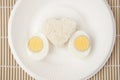 Rice heart and egg on white plate Royalty Free Stock Photo