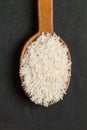 Rice Jasmine in an wooden spoon on a black background