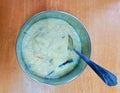 Rice kheer (sweet pudding) served in a steel bowl and with a spoon