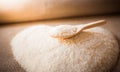 Rice laid out in a heart shape on sackcloth with wooden spoon Royalty Free Stock Photo