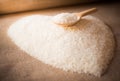 Rice laid out in a heart shape on sackcloth with wooden spoon Royalty Free Stock Photo