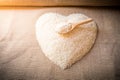 Rice laid out in a heart shape on sackcloth Royalty Free Stock Photo