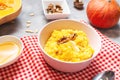 Rice milk pumpkin porridge with walnuts, butter and honey on concrete table. Healthy food. Royalty Free Stock Photo