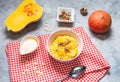 Rice milk pumpkin porridge with walnuts, butter and honey on concrete table. Healthy food. Royalty Free Stock Photo