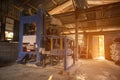 Rice milling machine in the old barn with orange light at rural Thailand. Rice grinder in the house with sunset