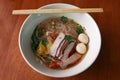 Rice noodle soup and wonton with barbecued red pork and meat ball in the bowl