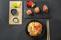 Rice noodles or crystal with other Asian food on a dark background. Teriyaki chicken and roasted Korean vegetables