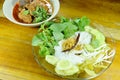 rice noodles and fresh vegetable with spicy chop pork and bone red cotton tree sauce