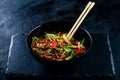 Rice noodles with vegetable stir fry on the ceramic plate on dark background Royalty Free Stock Photo