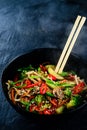Rice noodles with vegetable stir fry on the ceramic plate on dark background Royalty Free Stock Photo