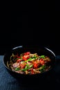 Rice noodles with vegetable stir fry on the ceramic plate on dark background Royalty Free Stock Photo