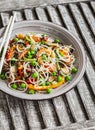 Rice noodles with vegetable stir fry on the ceramic plate Royalty Free Stock Photo