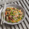 Rice noodles with vegetable stir fry on the ceramic plate Royalty Free Stock Photo