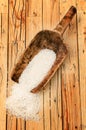 Rice in an old wooden scoop on table