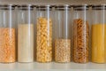 Rice, peas, pasta, oats, cereals, seeds in glass transparent jars for kitchen storage, food pantry, kitchen order Royalty Free Stock Photo