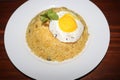 Rice plate with egg yolk, plums, mint leaf,lemon slice on white plate on wood table Royalty Free Stock Photo