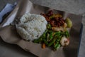 Rice and pork in sweet sauce with stir fried beans and shrimps. Street food in Singapore. T