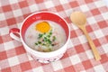 Rice porridge with egg in cute bowl