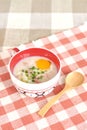 Rice porridge with egg in cute bowl