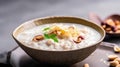 Rice porridge with nuts in a bowl on a dark background