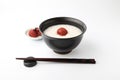 rice porridge with salt pickled plum in bowl chopsticks isolated on white background Royalty Free Stock Photo