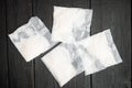 Rice in portion bags, on old dark wooden table background, on old black wooden table background, top view flat lay