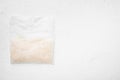 Rice in portion bags, on white stone table background, top view flat lay, with copy space for text