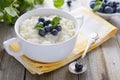 Rice pudding with bilberry in white bowl
