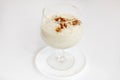 Rice pudding dessert served in large glass goblet with powdered cinnamon