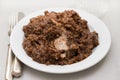 Rice with rabbit on dish on wooden background