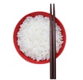 Rice in a red ceramic bowl on a white background. Top view Royalty Free Stock Photo