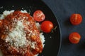 Rice with sauce, meatballs and parmesan next to a fork and cherry tomatoes Royalty Free Stock Photo