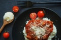 Rice with sauce, meatballs and parmesan next to a fork and cherry tomatoes Royalty Free Stock Photo