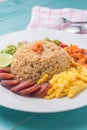 Rice Seasoned with Shrimp Paste, Thai food on white dish over wooden table. Royalty Free Stock Photo