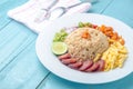 Rice Seasoned with Shrimp Paste, Thai food on white dish over wooden table. Royalty Free Stock Photo