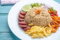 Rice Seasoned with Shrimp Paste, Thai food on white dish over wooden table. Royalty Free Stock Photo