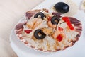 Rice in the shell, decorated with seafood, shrimps, mussels, squid rings and olives. Royalty Free Stock Photo