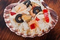 Rice in the shell, decorated with seafood, shrimps, mussels, squid rings and olives. Royalty Free Stock Photo