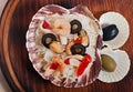 Rice in the shell, decorated with seafood, shrimps, mussels, squid rings and olives. Royalty Free Stock Photo