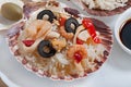 Rice in the shell, decorated with seafood, shrimps, mussels, squid rings and olives. Royalty Free Stock Photo