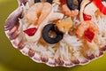 Rice in the shell, decorated with seafood, shrimps, mussels, squid rings and olives. Royalty Free Stock Photo