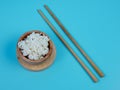 rice in a small wooden bowl and chopsticks Royalty Free Stock Photo