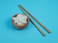 rice in a small wooden bowl and chopsticks Royalty Free Stock Photo