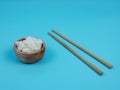 rice in a small wooden bowl and chopsticks Royalty Free Stock Photo