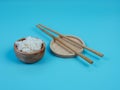 rice in a small wooden bowl and chopsticks Royalty Free Stock Photo