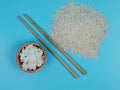 rice in a small wooden bowl with chopsticks and scattered rice Royalty Free Stock Photo