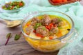 Rice soup with meat balls and vegetables in a transparent glass bowl. Royalty Free Stock Photo