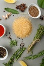 Rice, spicy herbs and spices on a light gray stone table.